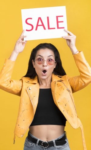 woman-yellow-jacket-holding-sale-banner